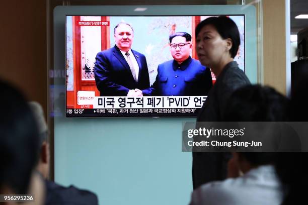 South Koreans watch on a screen reporting the U.S. Secretary of State Mike Pompeo visit to North Korea at the Seoul Railway Station on May 9, 2018 in...