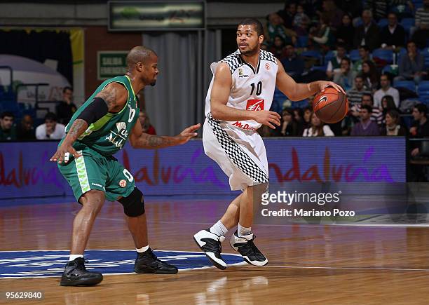 Aldo Curti, #10 of Entente Orleanaise competes with Omar Cook, #00 of Unicaja, during the Euroleague Basketball Regular Season 2009-2010 Game Day 9...