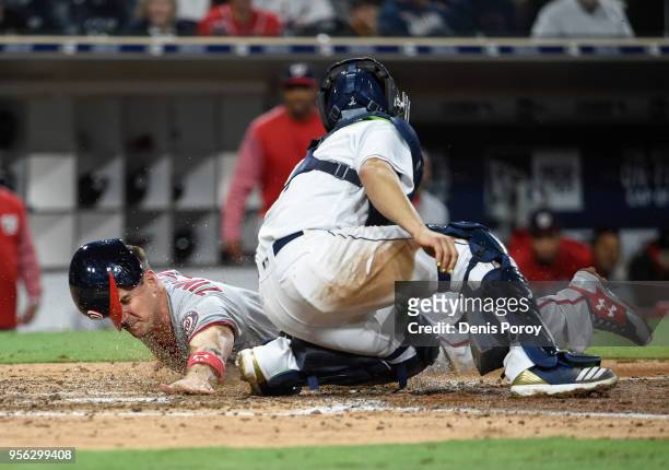 Ryan Zimmerman of the Washington Nationals scores ahead of the tag of Raffy Lopez of the San Diego Padres during the ninth inning of a baseball game...