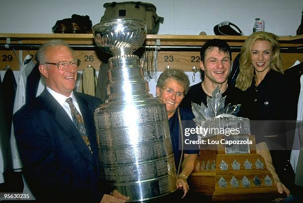 New Jersey Devils Claude Lemieux victorious in locker room with Stanley Cup trophy and Conn Smythe trophy after winning Game 4 and series vs Detroit...