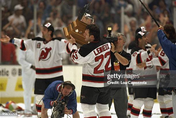New Jersey Devils Claude Lemieux victorious, holding Conn Smythe trophy after winning Game 4 and series vs Detroit Red Wings. East Rutherford, NJ...