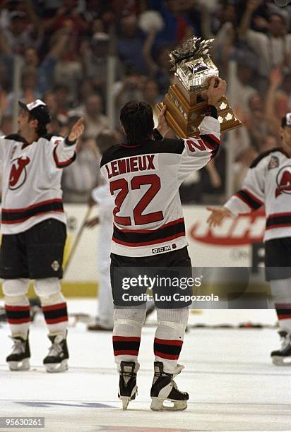 New Jersey Devils Claude Lemieux victorious, holding Conn Smythe trophy after winning Game 4 and series vs Detroit Red Wings. East Rutherford, NJ...