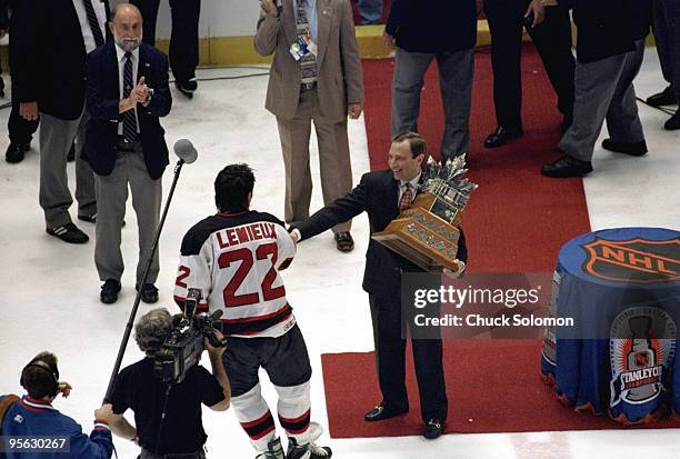 Aerial view of NHL commissioner Gary Bettman presenting Conn Smythe trophy to New Jersey Devils Claude Lemieux after Game 4 vs Detroit Red Wings....