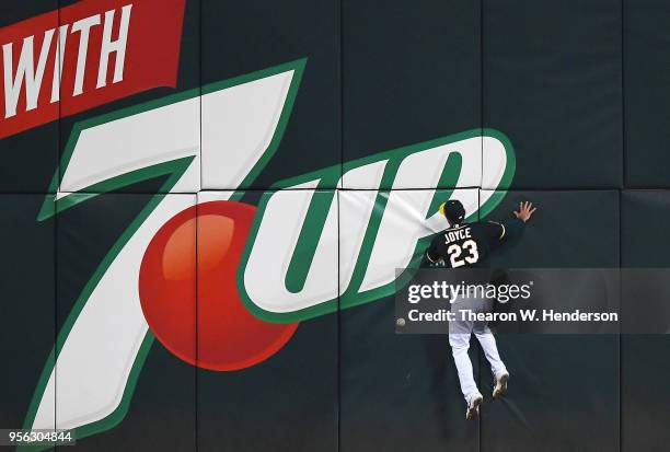 Matt Joyce of the Oakland Athletics collides with the left centerfield wall going after this ball that goes for a two-run RBI double off the bat of...