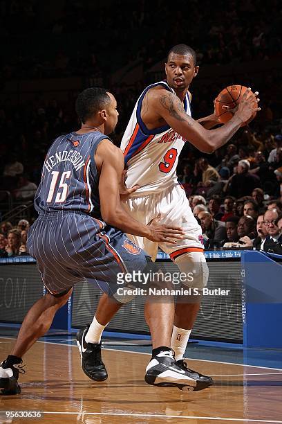 Jonathan Bender of the New York Knicks handles the ball against Gerald Henderson of the Charlotte Bobcats during the game on December 20, 2009 at...