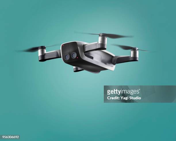 a flying drone - flying drone stock-fotos und bilder
