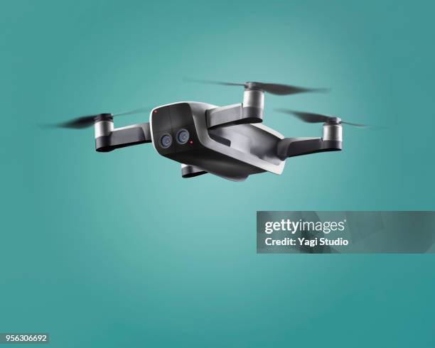 a flying drone - drones stock pictures, royalty-free photos & images