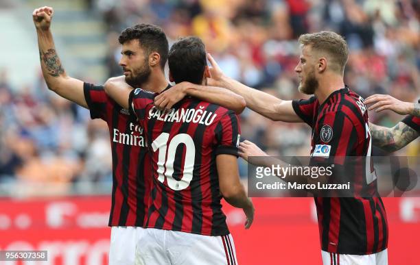 Patrick Cutrone of AC Milan celebrates his goal with his team-mates Hakan Calhanoglu and Ignazio Abate during the serie A match between AC Milan and...