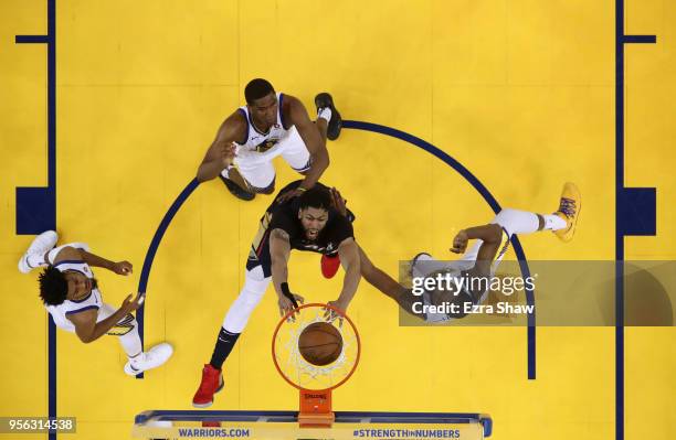 Anthony Davis of the New Orleans Pelicans goes up for a dunk on Quinn Cook, Kevon Looney, and Kevin Durant of the Golden State Warriors during Game...