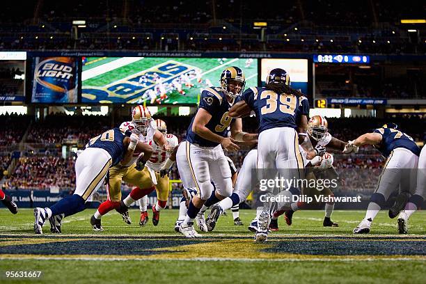 Quarterback Keith Null of the St. Louis Rams hands off the ball to Steven Jackson during the game against the San Francisco 49ers at the Edward Jones...