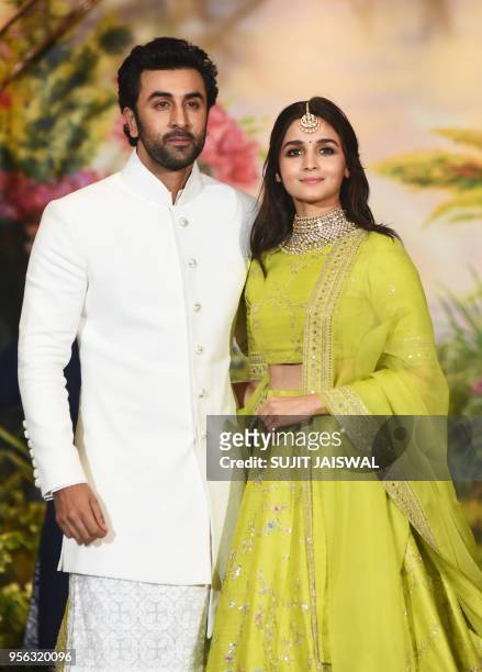 Indian Bollywood actors Ranbir Kapoor and Alia Bhatt pose for a picture during the wedding reception of actress Sonam Kapoor and businessman Anand...