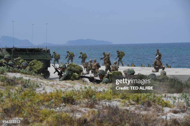 Philippine and US marines simulate an amphibious landing as part of the annual joint military exercise at the beach of Philippine navy's training...