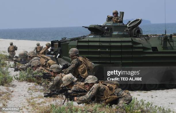 Marines aboard their assault amphibious vehicle simulate an amphibious landing as part of the annual joint military exercise at the beach of...