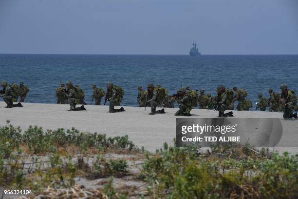 Philippine marines take position to simulate with their US counterpart an amphibious landing as part of the annual joint military exercise at the...