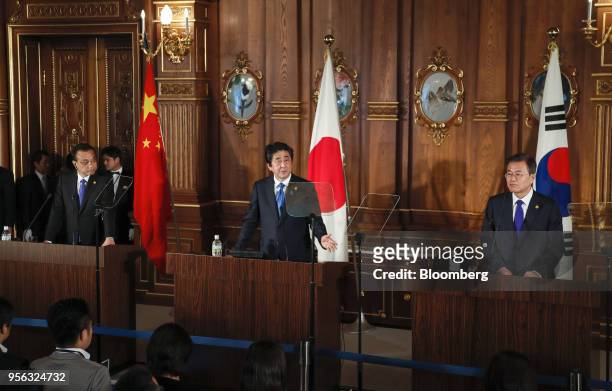 Shinzo Abe, Japan's prime minister, center, speaks as Li Keqiang, China's premier, left, and Moon Jae-in, South Korea's president, look on during a...