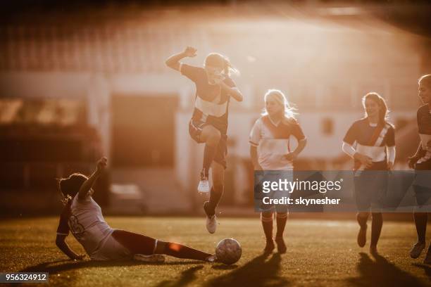 tackling the rival on woman's soccer match! - defender soccer stock pictures, royalty-free photos & images