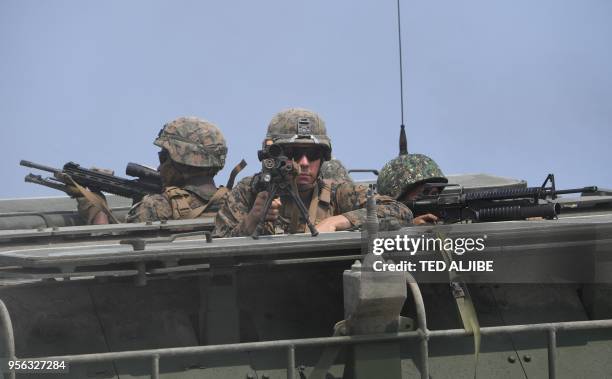 Philippine and US marines take position aboard an assault amphibious vehicle during the amphibious landing as part of the annual Philippines and US...