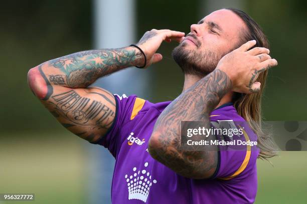 Sandor Earl ties up his hair during a Melbourne Storm NRL training session at AAMI Park on May 9, 2018 in Melbourne, Australia.