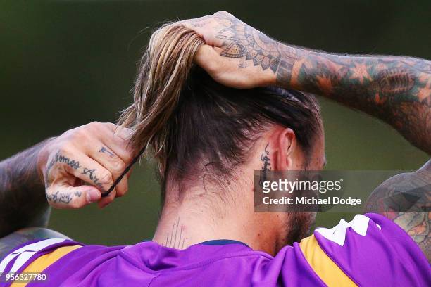 Sandor Earl ties up his hair during a Melbourne Storm NRL training session at AAMI Park on May 9, 2018 in Melbourne, Australia.