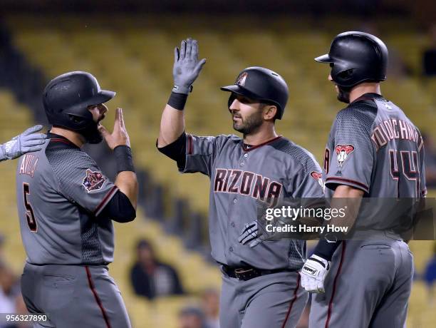 Daniel Descalso of the Arizona Diamondbacks celebrates his three run homerun with Alex Avila and Paul Goldschmidt, to take an 8-5 lead over the Los...