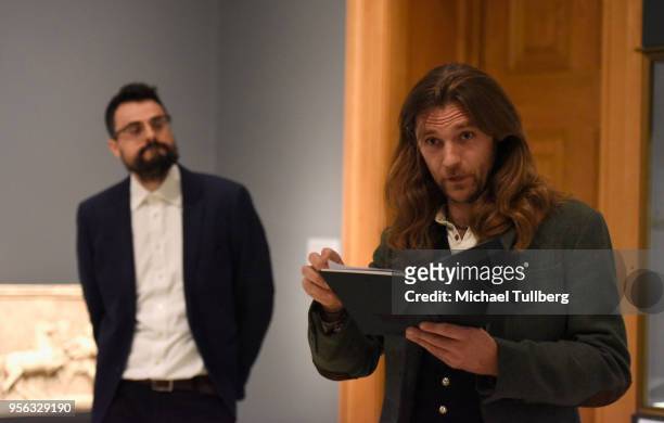 Poet Gabriele Tinti watches as filmmaker Oscar Sharp recites Tinti's poetry at BritWeek at The Getty Villa on May 8, 2018 in Pacific Palisades,...