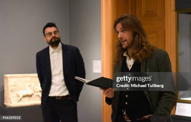 Poet Gabriele Tinti watches as filmmaker Oscar Sharp recites Tinti's poetry at BritWeek at The Getty Villa on May 8, 2018 in Pacific Palisades,...