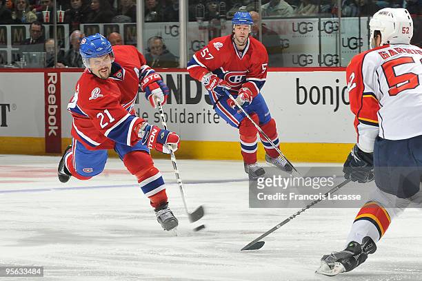 Brian Gionta of Montreal Canadiens takes a shot in front of Jason Garrison of the Florida Panthers during the NHL game on January 7, 2010 at the Bell...