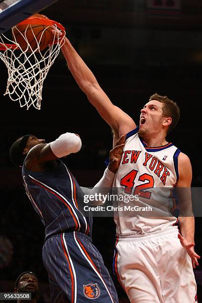 David Lee of the New York Knicks dunks on Gerald Wallace of the Charlotte Bobcats at Madison Square Garden January 7, 2010 in New York City. NOTE TO...