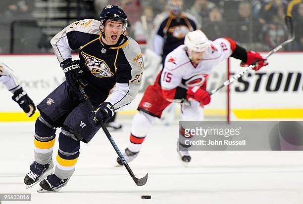 Dumont of the Nashville Predators leads a breakaway against Tuomo Ruutu of the Carolina Hurricanes on January 7, 2010 at the Sommet Center in...
