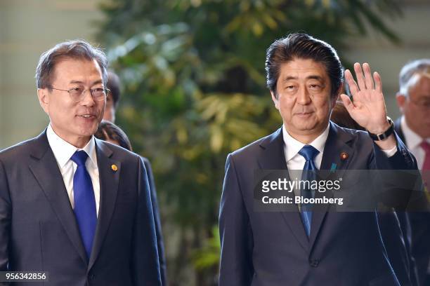 Moon Jae-in, South Korea's president, left, is greeted by Shinzo Abe, Japan's prime minister, as they arrive for their bilateral summit in Tokyo,...
