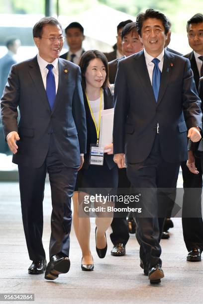 Moon Jae-in, South Korea's president, left, is greeted by Shinzo Abe, Japan's prime minister, as they arrive for their bilateral summit in Tokyo,...