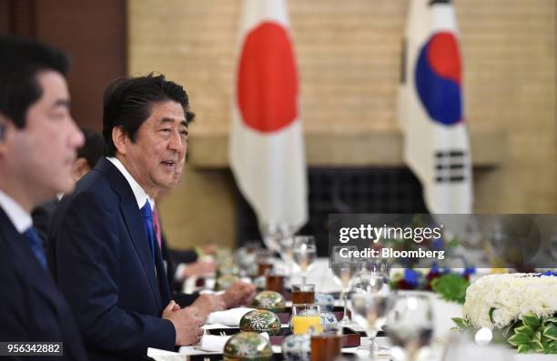 Shinzo Abe, Japan's prime minister, second left, speaks during a luncheon with Moon Jae-in, South Korea's president, not pictured, during a bilateral...