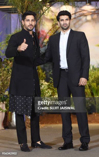 Indian Bollywood actors Sidhharth Malhotra and Aditya Roy Kapur pose for a picture during the wedding reception of actress Sonam Kapoor and...