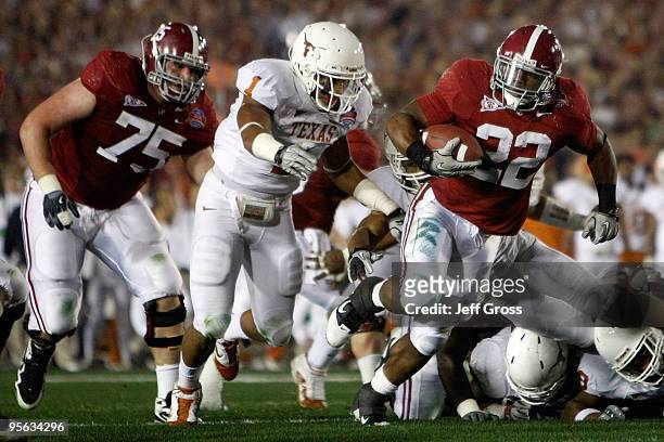 Running back Mark Ingram of the Alabama Crimson Tide runs with the ball as Keenan Robinson of the Texas Longhorns tries to tackle during the Citi BCS...