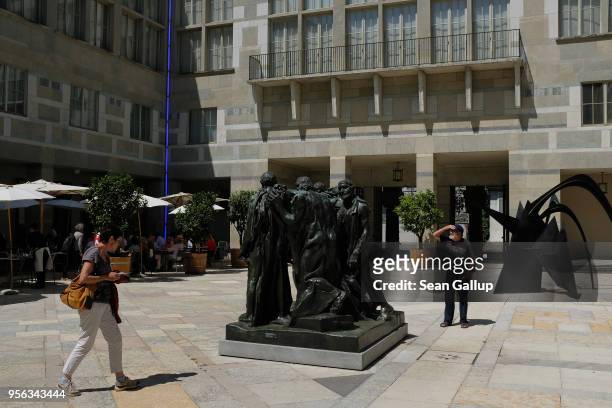 Visitors look at a sculpture by August Rodin in the courtyard of Kunstmuseum Basel art museum on May 8, 2018 in Basel, Switzerland. Basel, a quiet...