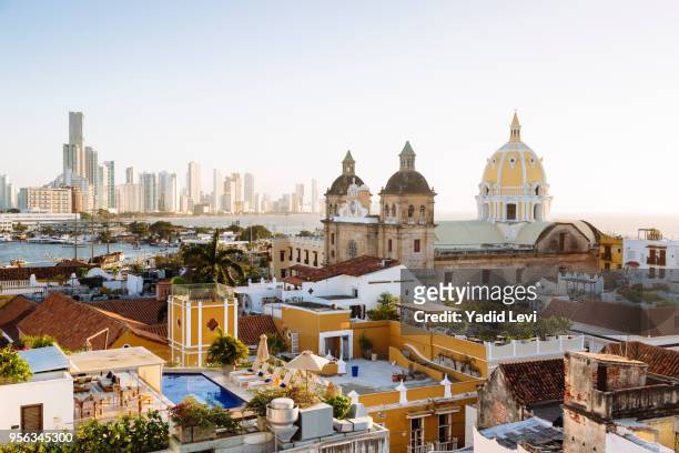 skyline of cartagena with the church of san pedro claver and monastery and the modern building of bocagrande in the background. cartagena de indias, colombia. - cartagena foto e immagini stock