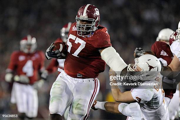 Quarterback Garrett Gilbert of the Texas Longhorns tries to tackle lineman Marcell Dareus of the Alabama Crimson Tide who would score after...