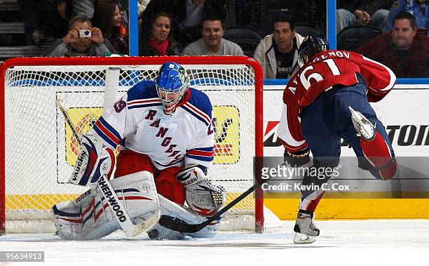 Goaltender Chad Johnson of the New York Rangers saves a shot by Maxim Afinogenov of the Atlanta Thrashers during a shootout at Philips Arena on...