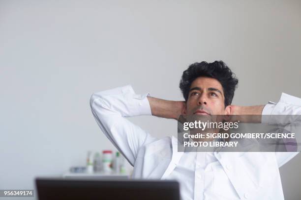 doctor thinking at his desk - sigrid gombert stock pictures, royalty-free photos & images