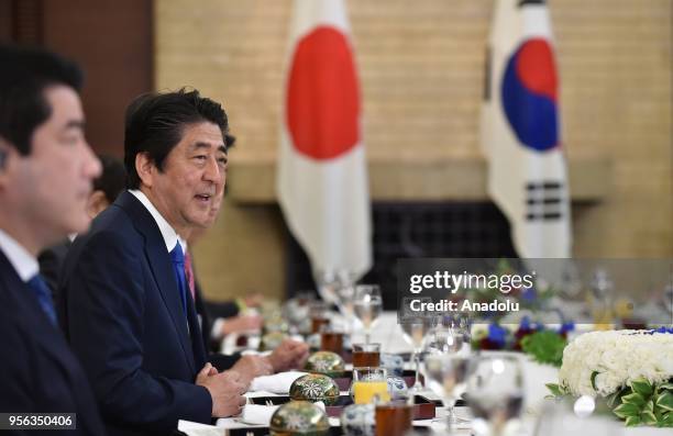Japan's Prime Minister Shinzo Abe speaks at the beginning of a luncheon meeting with South Korea's President Moon Jae-in at the Prime Minsiter's...