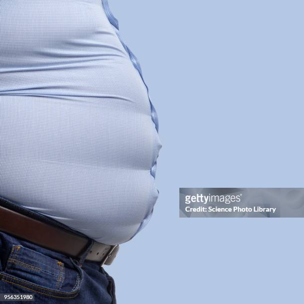 overweight man wearing blue shirt - dicker bauch stock-fotos und bilder