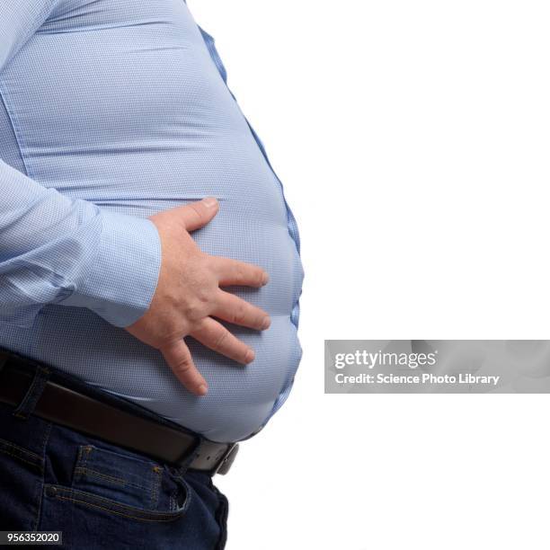 overweight man touching stomach - belly button ストックフォトと画像