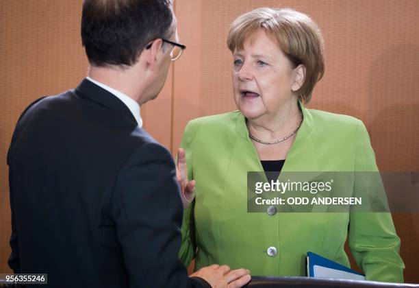 German Chancellor Angela Merkel speaks with German Foreign Minister Heiko Maas at the start of the weekly cabinet meeting at the Chancellery in...