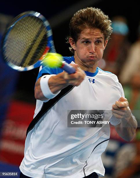 Igor Andreev of Russia returns against Andy Murray of Britain during their singles tennis match on the tenth session during day seven of the Hopman...