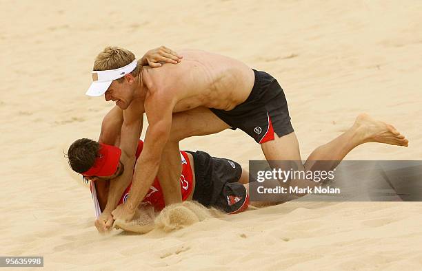 Ryan O'Keefe and Nick Malceski wrestle during a Sydney Swans AFL training session at the Kurnell sand dunes on January 8, 2010 in Sydney, Australia.