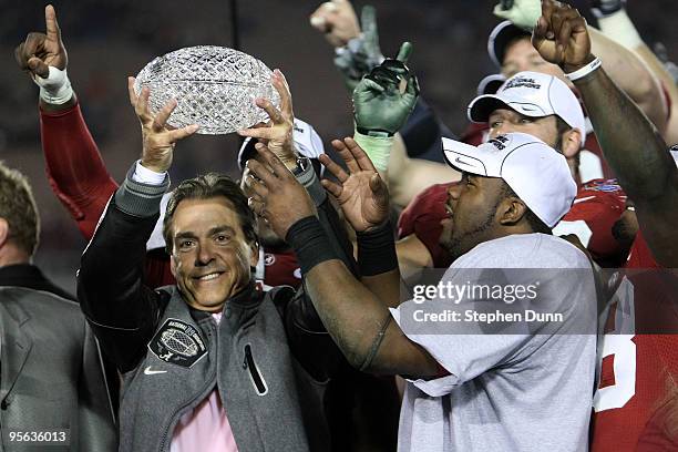 Head coach Nick Saban and running back Mark Ingram of the Alabama Crimson Tide celebrate with the BCS Championship trophy after winning the Citi BCS...