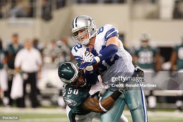 Tight end Jason Witten of the Dallas Cowboys is tackled by Will Witherspoon of the Philadelphia Eagles at Cowboys Stadium on January 3, 2010 in...