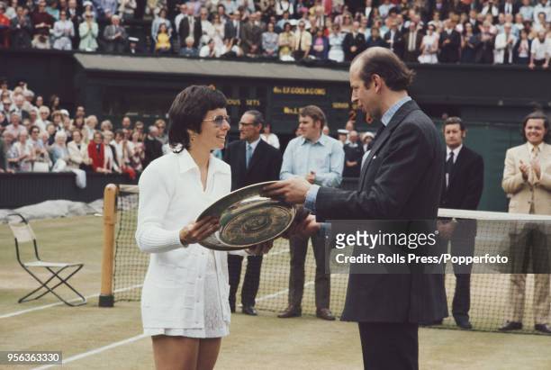 American tennis player Billie Jean King is presented with the Venus Rosewater Dish trophy by Prince Edward, Duke of Kent after beating Australian...