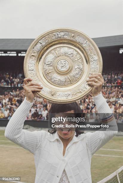 American tennis player Billie Jean King holds up the Venus Rosewater Dish trophy after beating Australian tennis player Evonne Goolagong 6-3, 6-3 in...