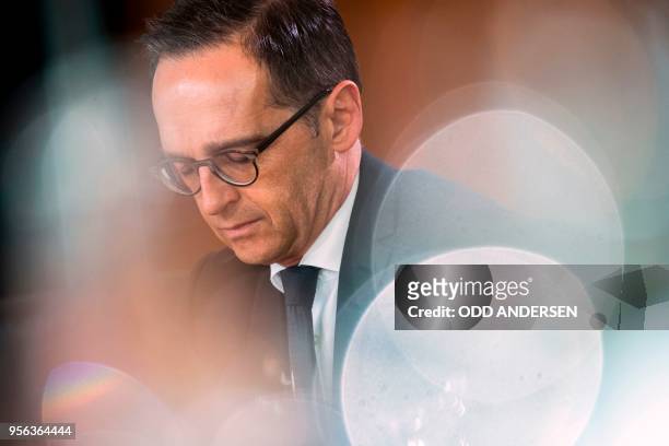 German Foreign Minister Heiko Maas reads a brief at the weekly cabinet meeting at the Chancellery in Berlin on May 9, 2018.
